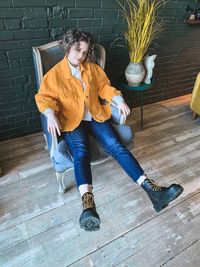 Portrait of a young woman sitting on floor