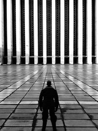 Rear view of man standing on tiled floor