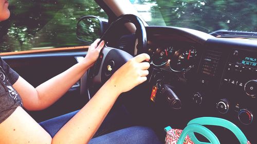 Close-up of woman sitting in car