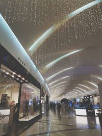 People walking in illuminated modern building at night