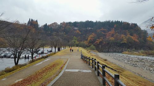 Panoramic view of people in park against sky