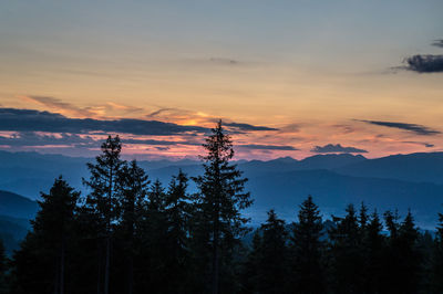 Scenic view of silhouette mountains against sky at sunset