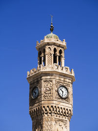 Low angle view of izmir clock tower against clear blue sky