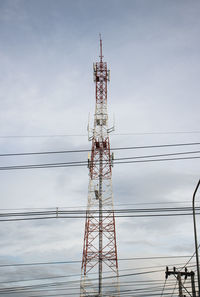 Low angle view of communications tower against sky