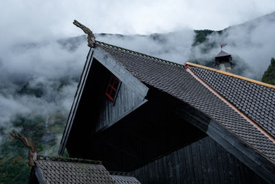 Low angle view of traditional building against cloudy sky