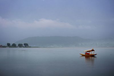 Scenic view of lake against cloudy sky