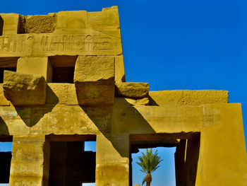 Low angle view of old temple against clear blue sky