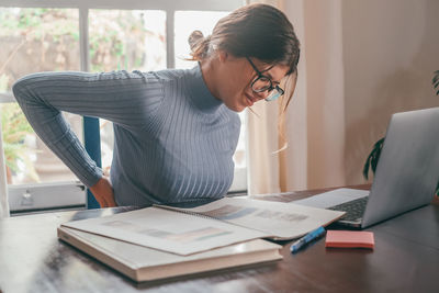 Side view of businesswoman working at office