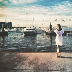 Woman standing on boat in river