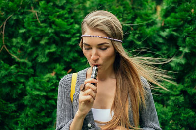 Portrait of a beautiful young woman drinking water