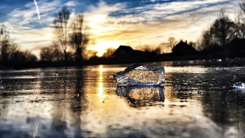 Scenic view of lake at sunset