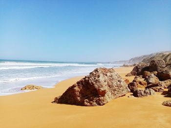 Scenic view of beach against clear sky