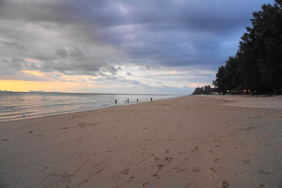 Scenic view of beach against sky during sunset