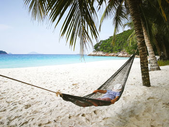 Girl resting on hammock at beach