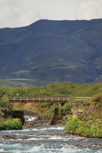 Scenic view of bridge over river against sky