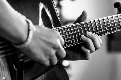 Close-up of man playing guitar