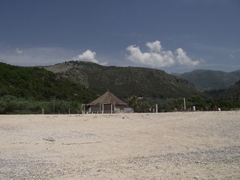 Scenic view of land and mountains against sky