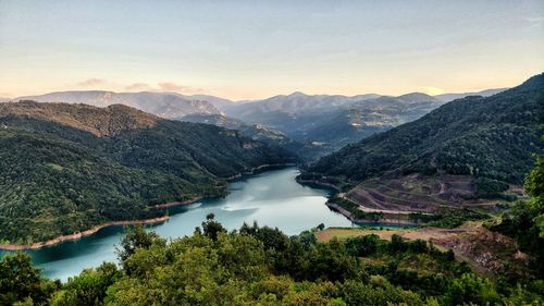 High angle view of lake and mountains against sky