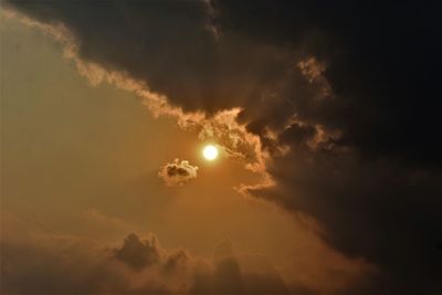 Low angle view of moon at sunset