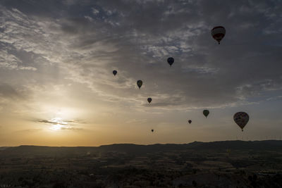 Hot air balloons flying in sky during sunset