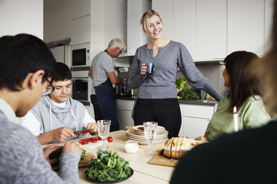 Family sitting at table and preparing meal