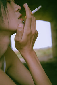 Close-up of woman hand holding cigarette