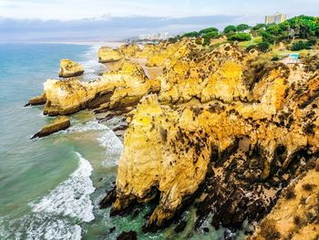 Scenic view of rocks in sea against sky