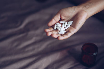 Close-up of hand holding pills