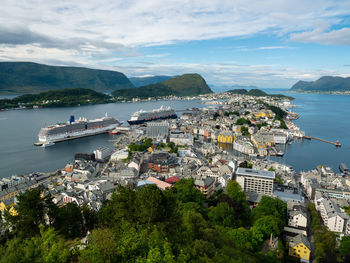 High angle view of bay and buildings against sky