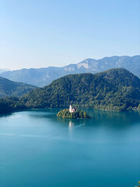 Scenic view of lake and mountains against sky