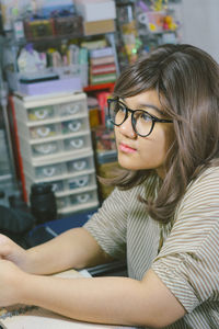 Portrait of young woman sitting at home