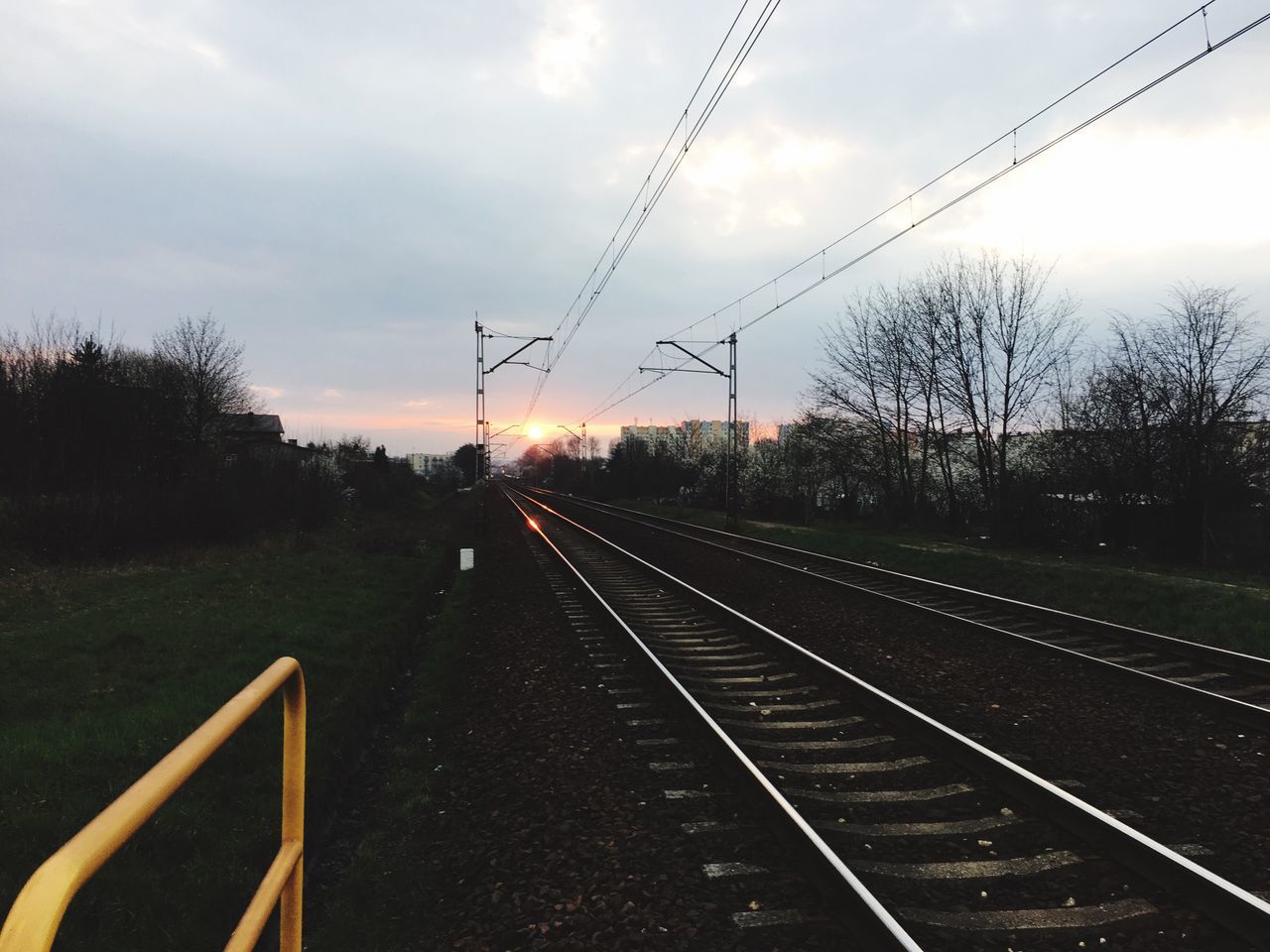 railroad track, transportation, rail transportation, public transportation, sky, diminishing perspective, the way forward, railway track, tree, vanishing point, train - vehicle, cloud - sky, travel, mode of transport, power line, electricity pylon, railroad station, railroad station platform, train, journey