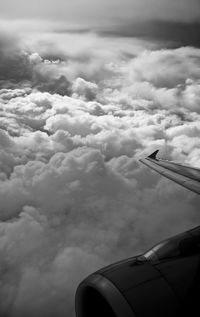 Low angle view of airplane flying over clouds