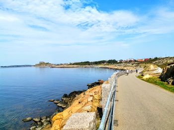 Panoramic view of road by sea against sky