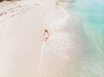 High angle view of man walking on beach