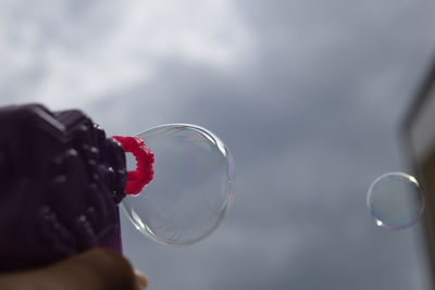 Close-up of hand holding bubbles