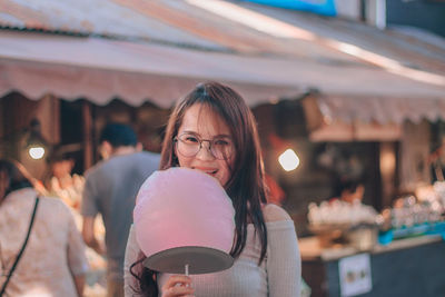Portrait of smiling woman cotton candy