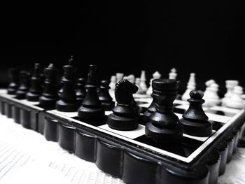 Close-up of chess board against black background