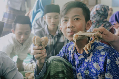  portrait of a boy with his friend in islamic religious activities