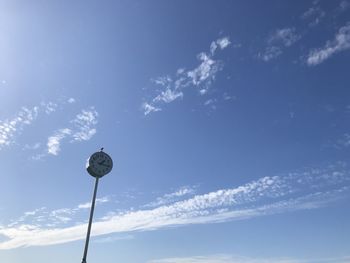 Low angle view of street light against blue sky