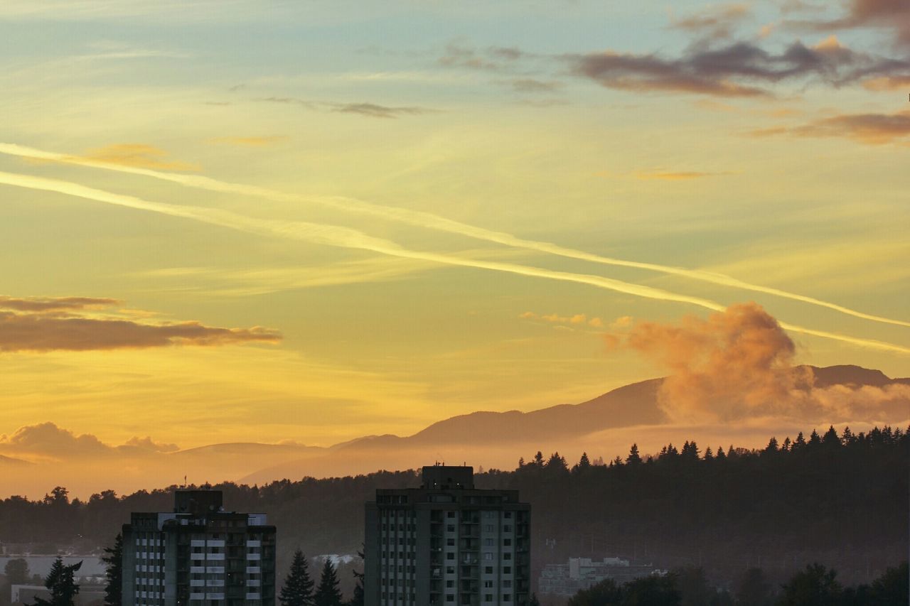 sunset, building exterior, architecture, sky, built structure, city, cloud - sky, orange color, scenics, beauty in nature, cityscape, silhouette, nature, cloud, mountain, residential building, outdoors, no people, sunlight, residential structure