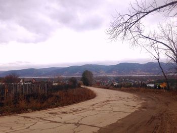 Scenic view of mountains against cloudy sky