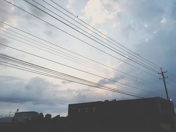 Low angle view of building against cloudy sky