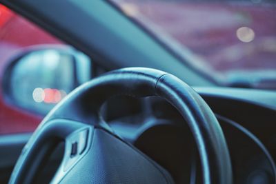 Close-up of steering wheel in car