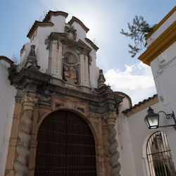 Low angle view of bell tower against sky