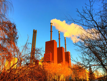 Low angle view of factory against sky