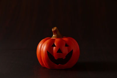 Close-up of pumpkin on table against black background