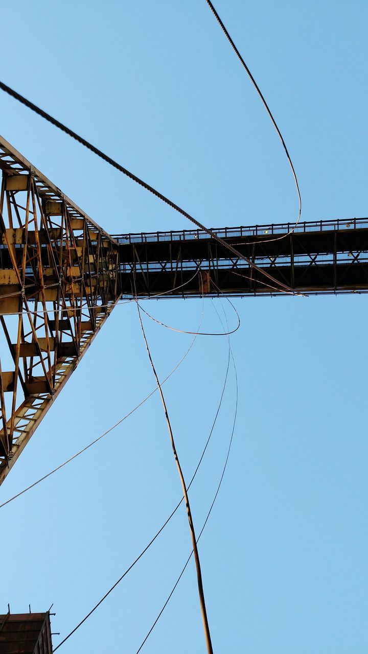 clear sky, low angle view, connection, built structure, power line, architecture, cable, blue, copy space, electricity pylon, power supply, electricity, fuel and power generation, building exterior, day, outdoors, power cable, technology, no people, metal