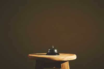 Close-up of electric lamp on table against black background