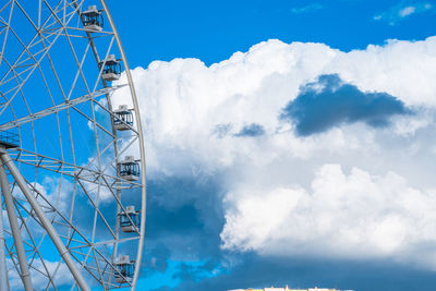 Low angle view of ferris wheel against sky